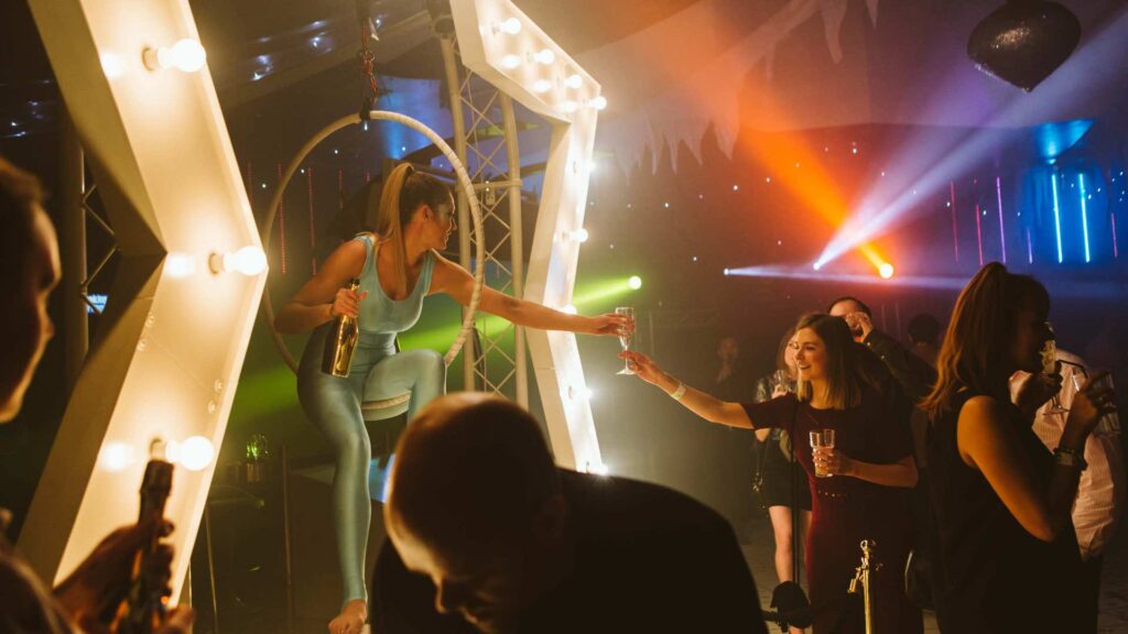 An aerialist handing out drinks to guests at an event in the UK