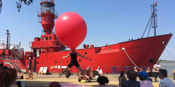 Watch the balloon man get inside a giant red balloon and pull of all sorts of balloon tomfoolery for his audience.