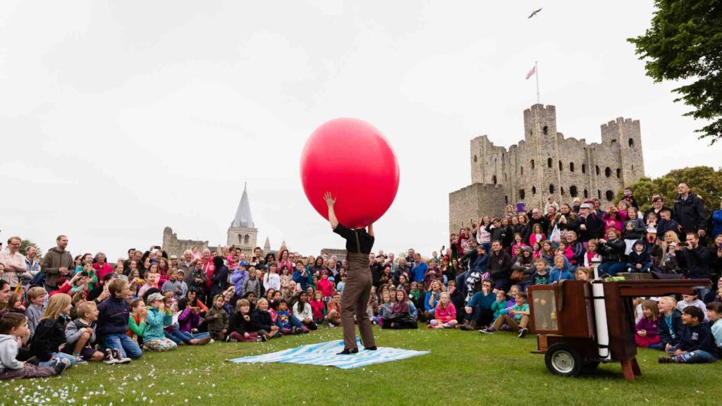 A with his head inside a giant balloon for a show