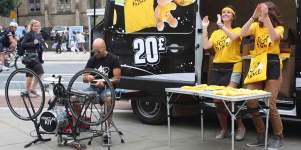 Intriguing street scene featuring a talented artist, drumming on a unique bicycle-turned-drum-kit, spreading joy through music.