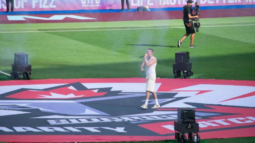 Aitch performing on centre circle at halftime of Sidemen Charity Match 2023.