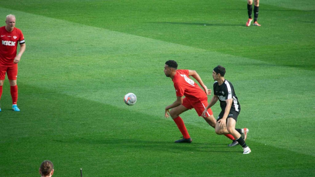 Niko tackling Tareq, gaining possession.