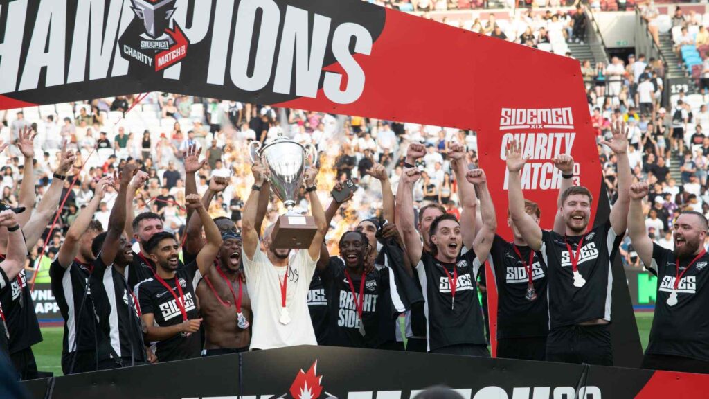 Billy Wingrove, Manager of Sidemen FC lifting the trophy with team.