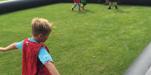 Children-Playing-On-Inflatable-Football-Pitch