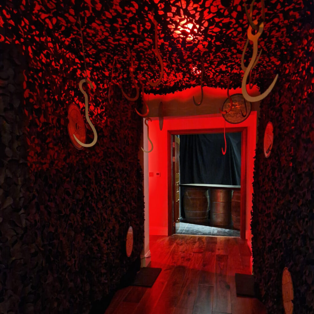 Hanging hooks and doorway designed with cult theming horror services in the UK.