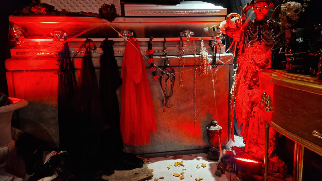 Bespoke coffin prop inside photo area of cult awakening themed halloween party.