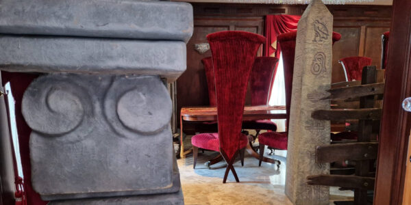 A cult themed dining area featuring eclectic seating, huge custom set props such as pillars and tombs. Given your guests the experience of being in a real life cult!