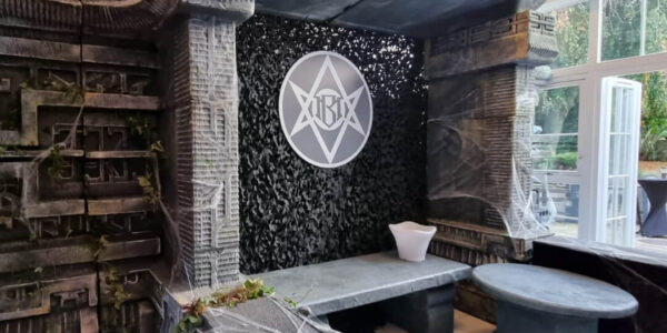 Custom horror set design featuring encrypted logos and signage.