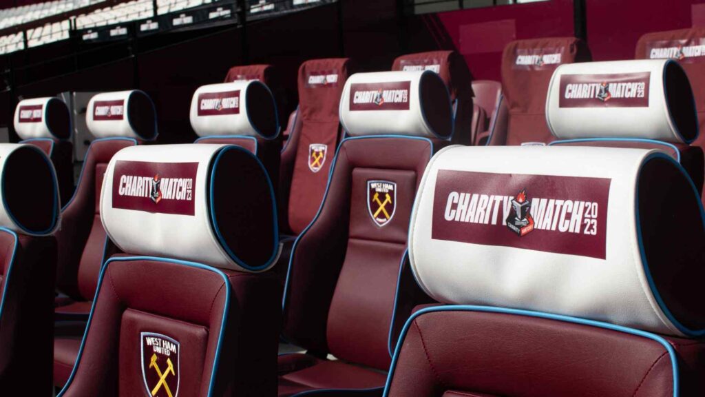 Close up of headrests on team seating area at the London Stadium branded with Sidemen Charity Match 2023 logos.