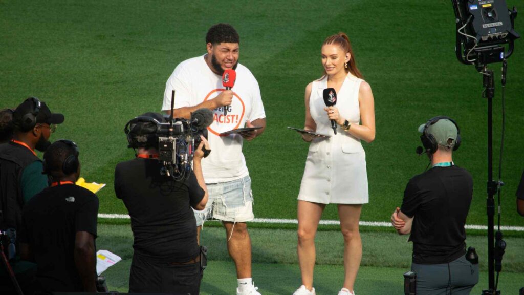 Big Zuu and Elz The Witch presenting pitch side, introducing Aitch's half time performance.