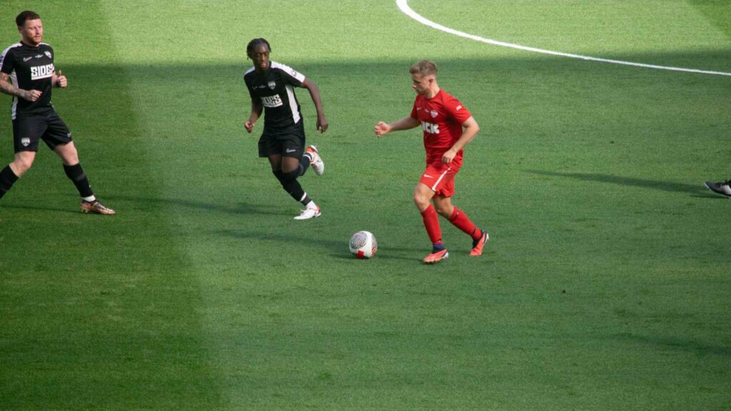 Chris MD dribbling, pushing forward past Manny.