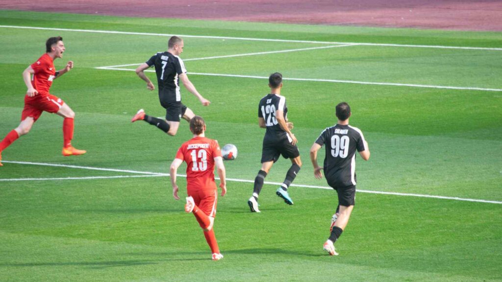 Miniminter shooting on target, scoring the third goal of the match.