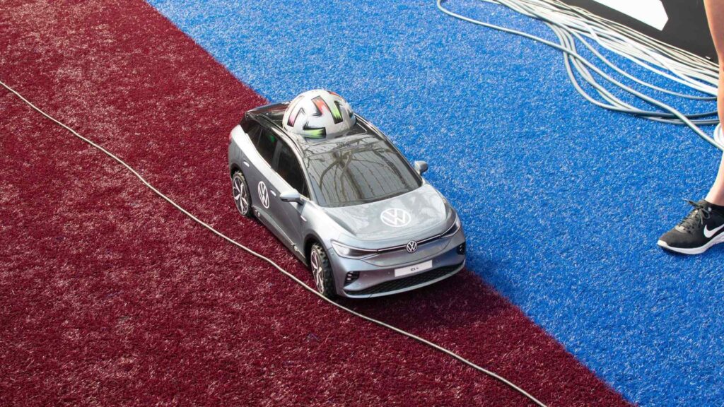 Volkswagen remote control car holding match ball used to bring the ball to the centre line.