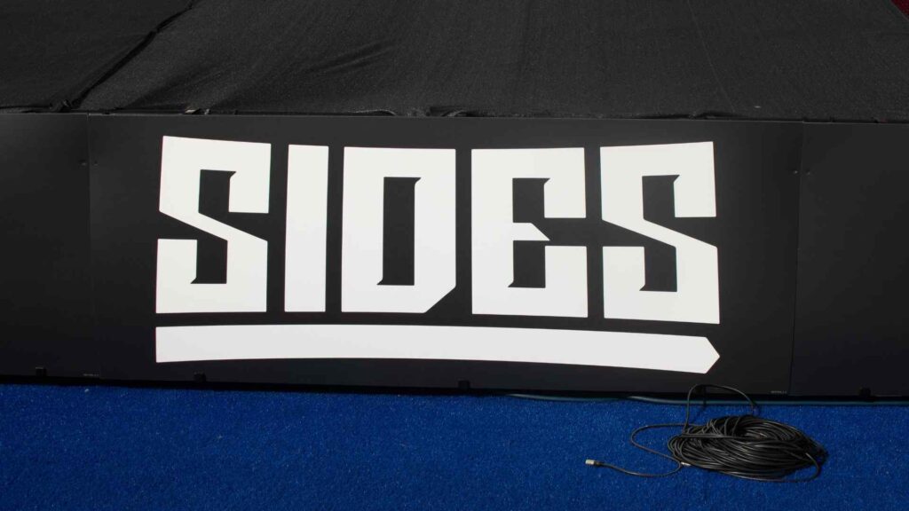 Sidemen Charity Match 2023 close-up of 'Sides' branded banners around pitch.