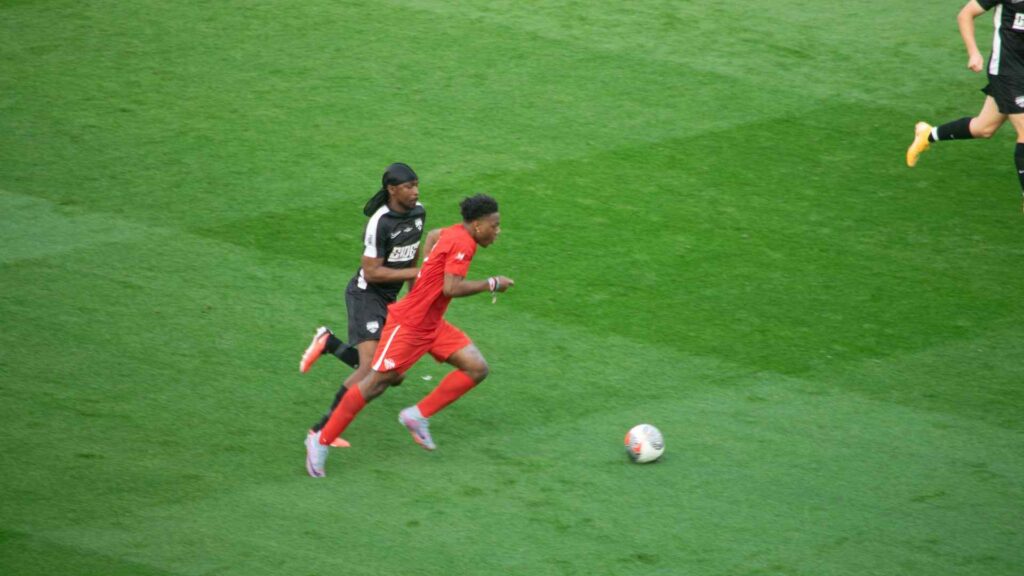 Speed sprinting past JME on the ball.