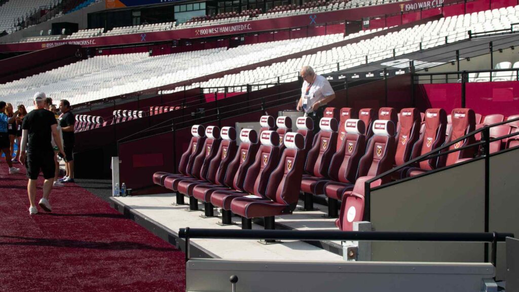 Team seating area at the London Stadium branded with Sidemen Charity Match 2023 logos.