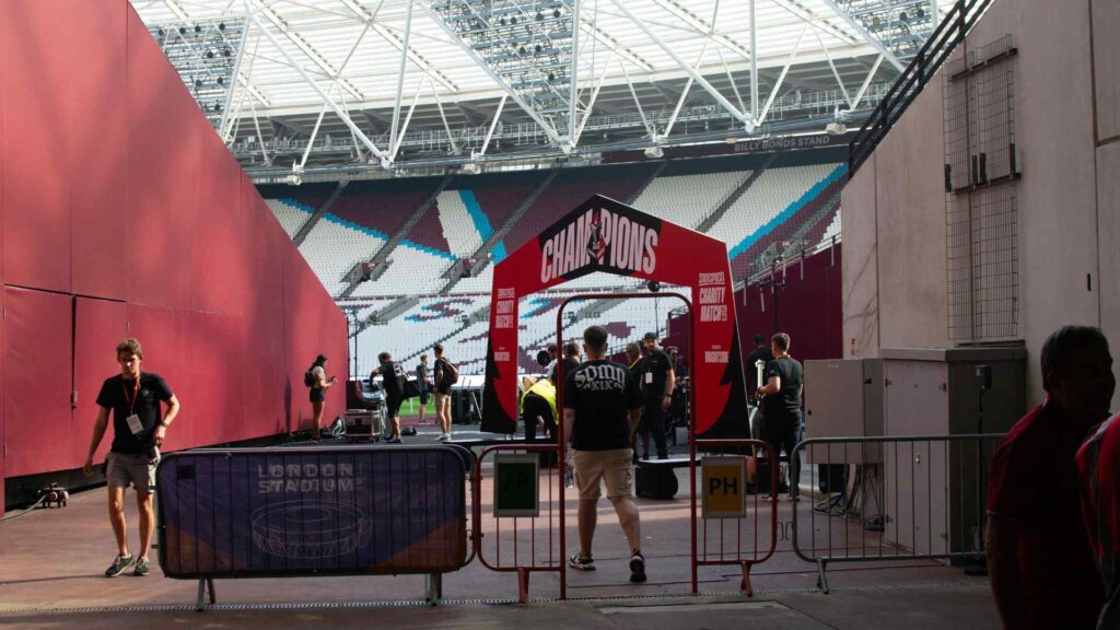 Production team bringing Sidemen Charity Match Winners facade on to pitch to rehearse prior to LIVE match.