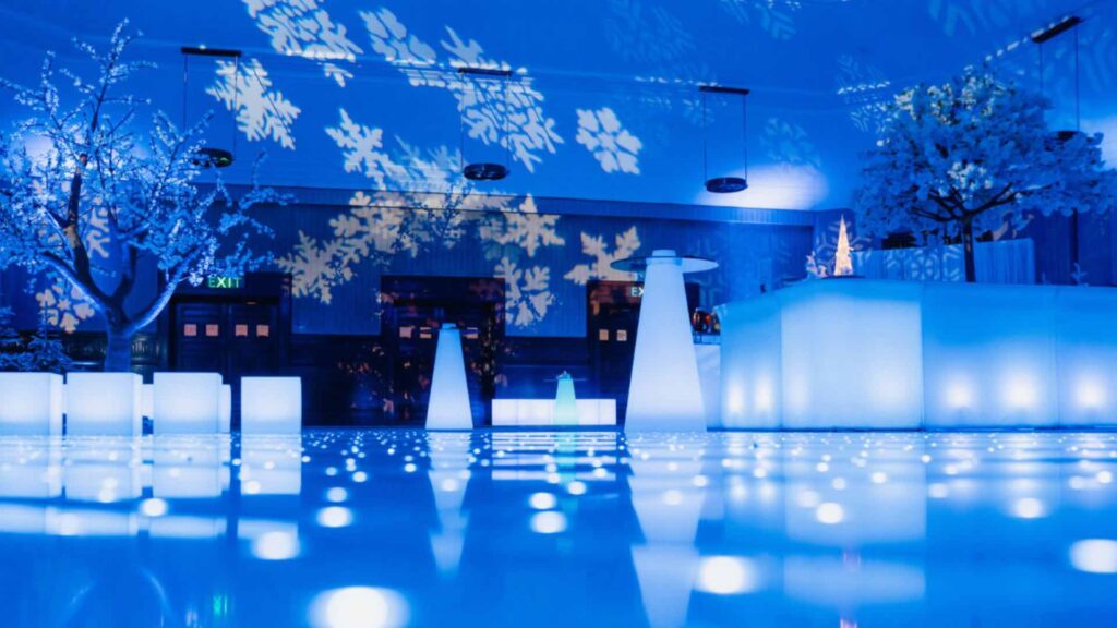 A dance floor and props illuminated in light for a Winter Wonderland Party.
