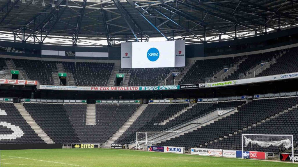 View of MK Dons stadium in Milton Keynes, with LED screen showing XERO content for a conference.