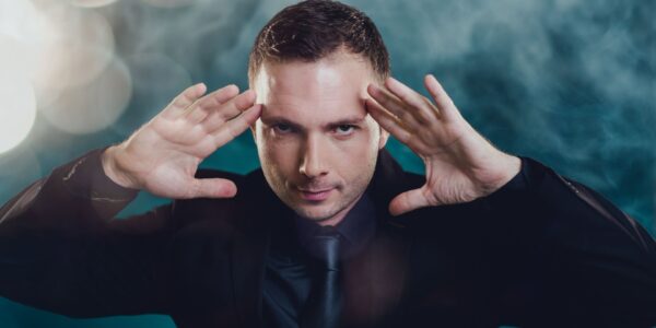 Magician-With-Hands-On-His-Head