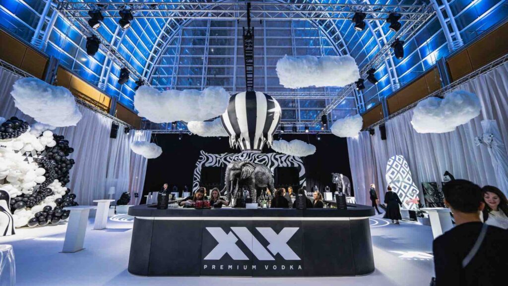 Sidemen dream circus theme including black and white draping, clouds and xxx bar.