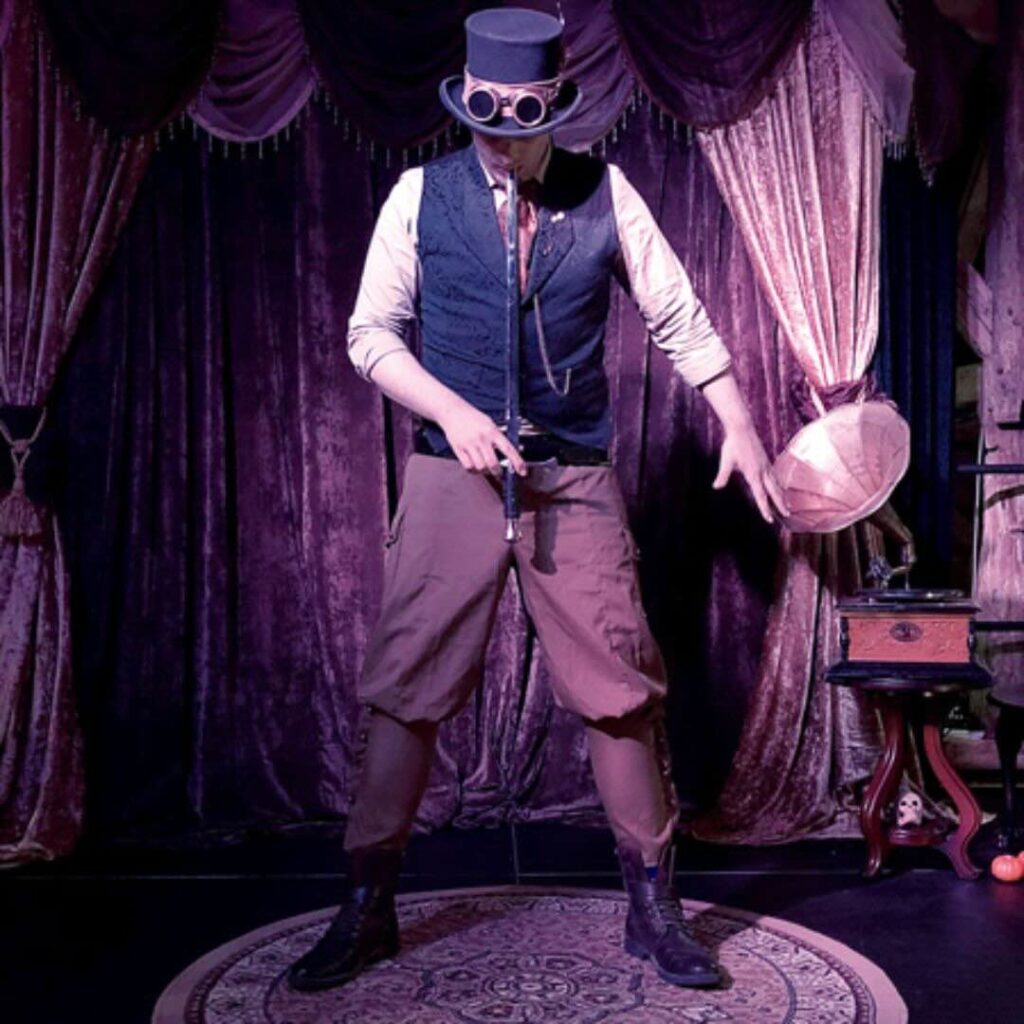 Man swallows sword in extreme steampunk circus act.