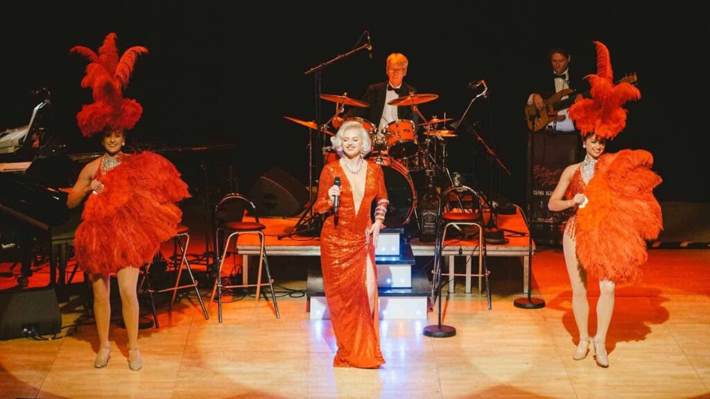 Marilyn Monroe lookalike impressing guests on stage as part of Hollywood theming entertainment.