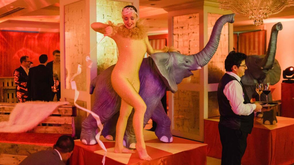 Performer stood with elephant prop who entertained guests a circus themed party we produced.