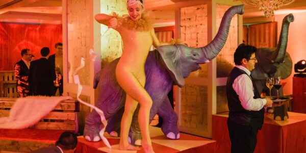 Performer stood with elephant prop who entertained guests a circus themed party we produced.