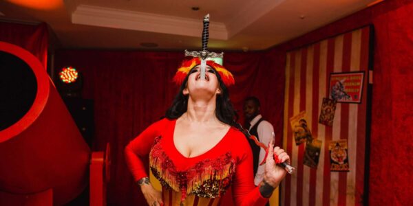 Incredible and scary sword swallowing act performing daring stunts at a circus themed party we managed.