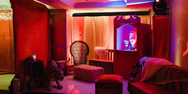 Circus ticket booth and seating area created for guests to chill out at a circus themed party.