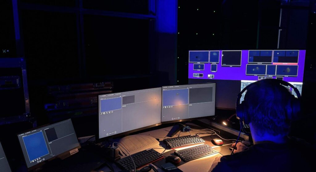 Conference technology showing different computer systems which help set up content.