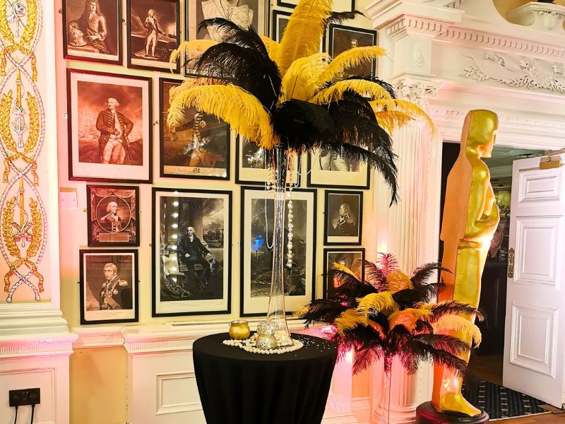 A gold and black feather table centrepiece light used for Hollywood theming.