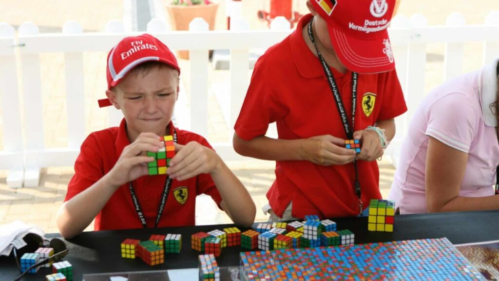 Kids interacting with rubiks cube art.