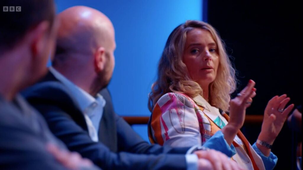 Julia Charles talking with other guest judges about the fallen escape room on BBC The Apprentice.