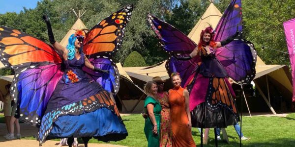 Butterfly-Stilt-Walkers-Posing-With-Guests-At-Festival-Theme-Event