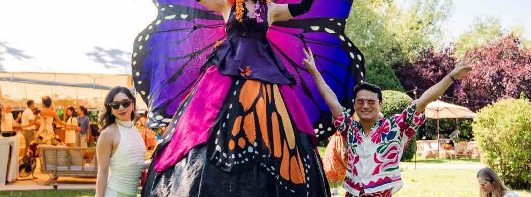 Our stunning Butterfly Stilt Walker posing with guests at a corporate festival held at Magna Carta Island in London for a conference.