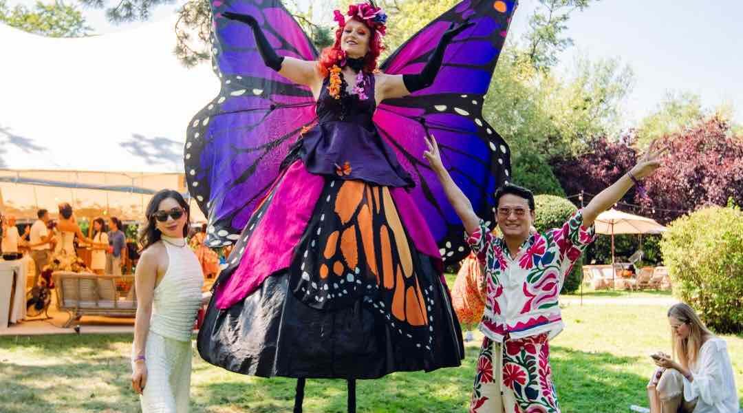 Our stunning Butterfly Stilt Walker posing with guests at a corporate festival held at Magna Carta Island in London for a conference.