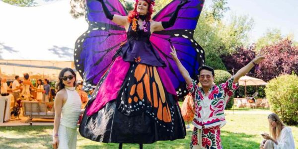 Our stunning Butterfly Stilt Walker posing with guests at a corporate festival held at Magna Carta Island in London for a conference.