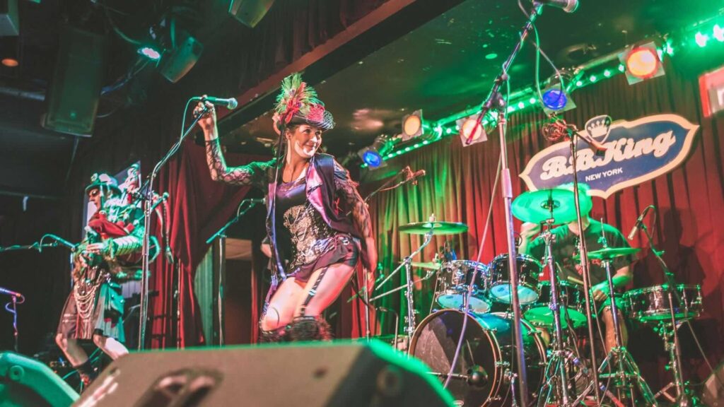 Bagpipers to hire performing on stage with green lighting