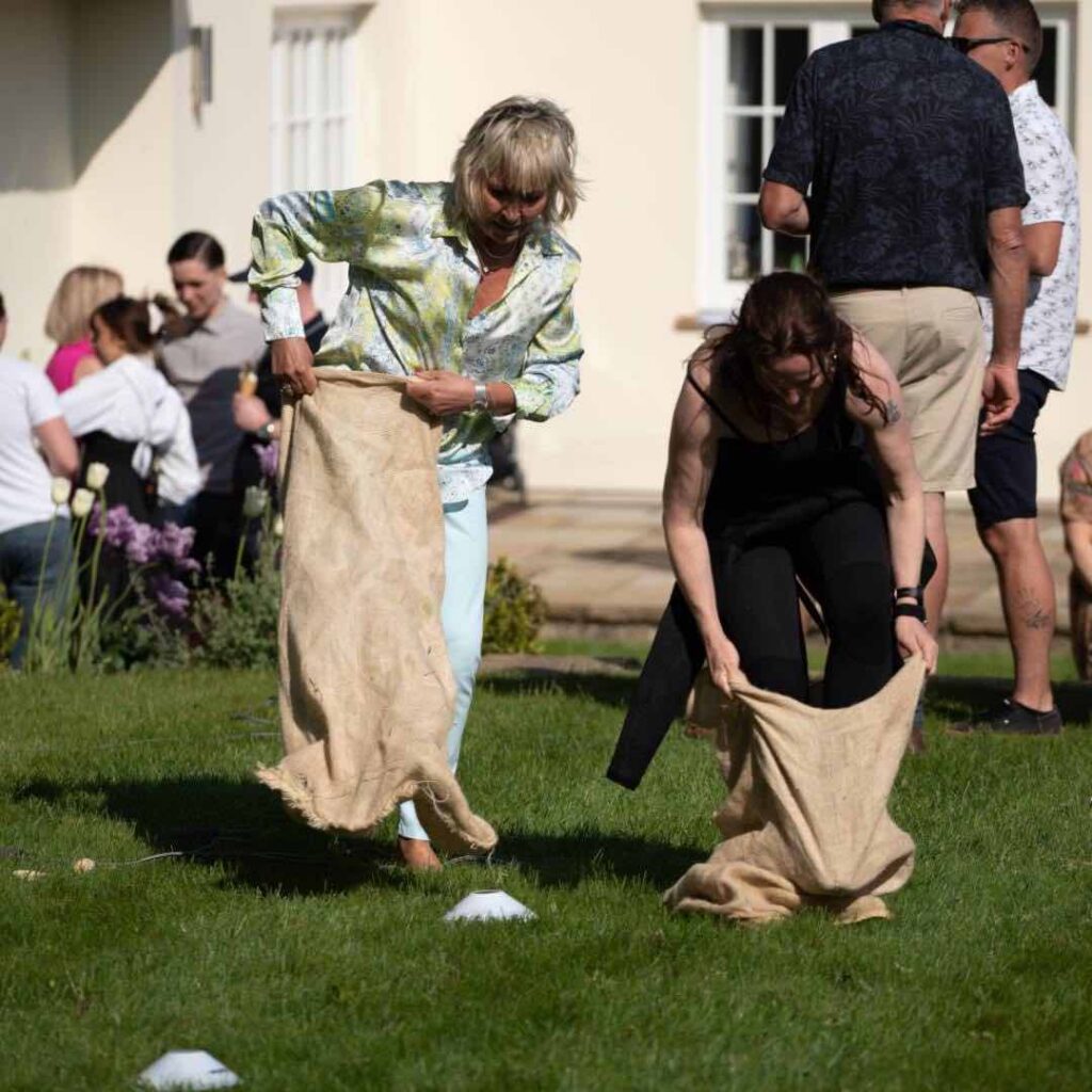 Family Fun Day activity involving beanbag racing and two ladies.