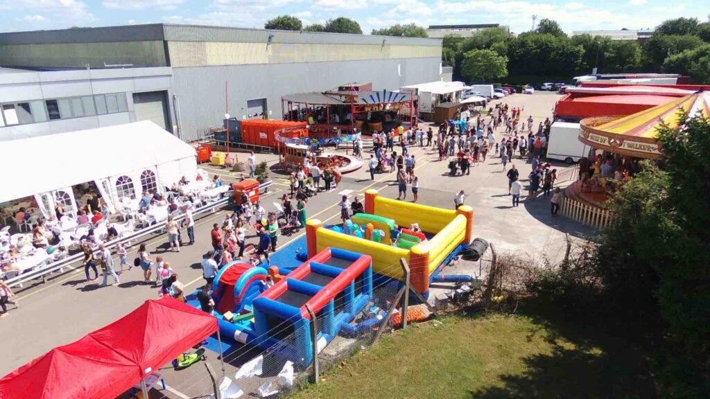 BSH family fun day event organised in a car park at their headquarters with fair games and inflatables. 