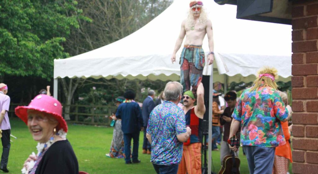 Acrobat on shoulders of another one at a festival theme event.