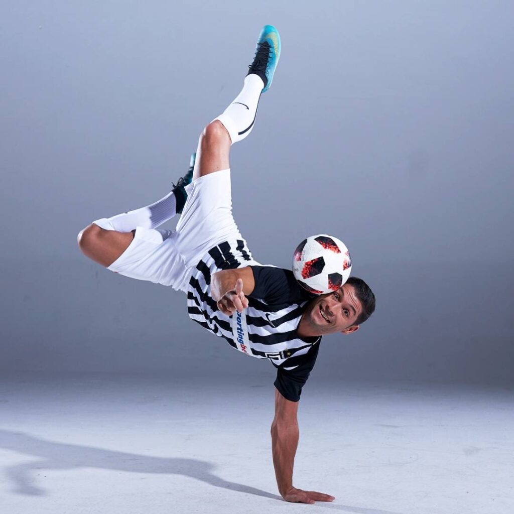 Cristiano Ronaldo performing football trick on his hands for the camera.
