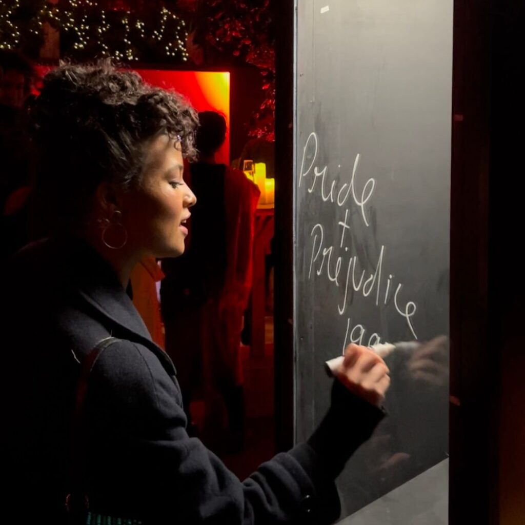 Guest writing message on interactive message booth.