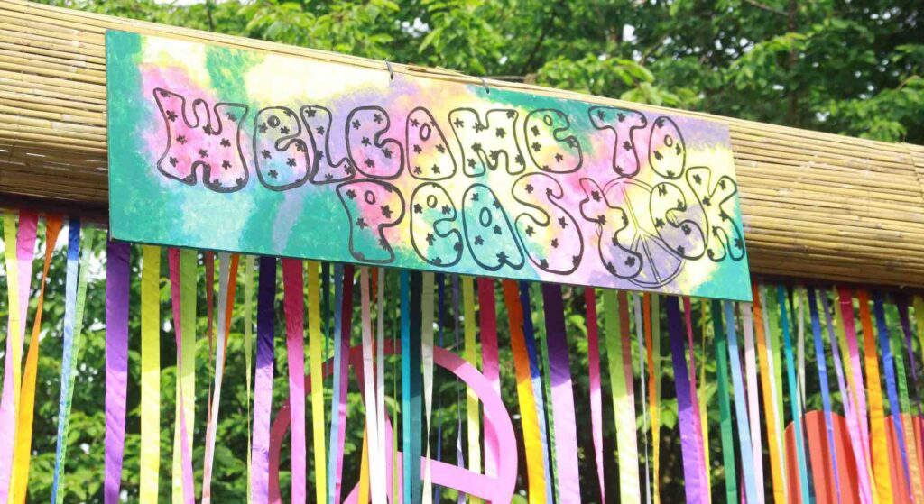 Festival party sign idea with colourful writing and ribbons.
