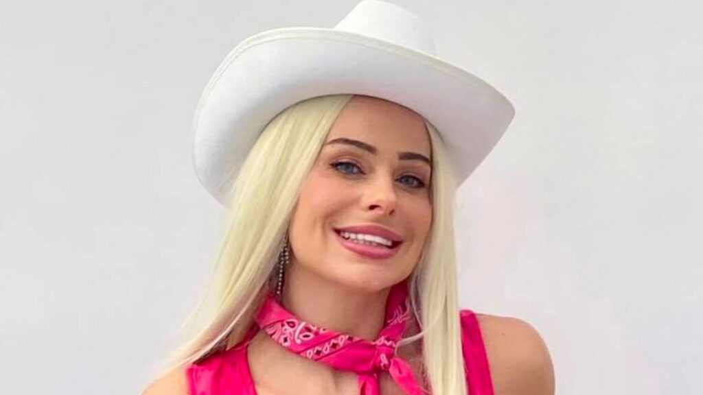 Realistic famous margot robbie lookalike dressed as pink cowgirl barbie available for events.
