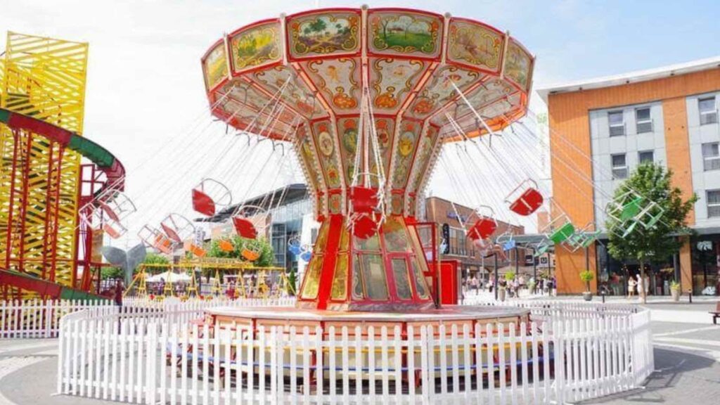 Swing carousel ride outdoors at a corporate family fun day event.