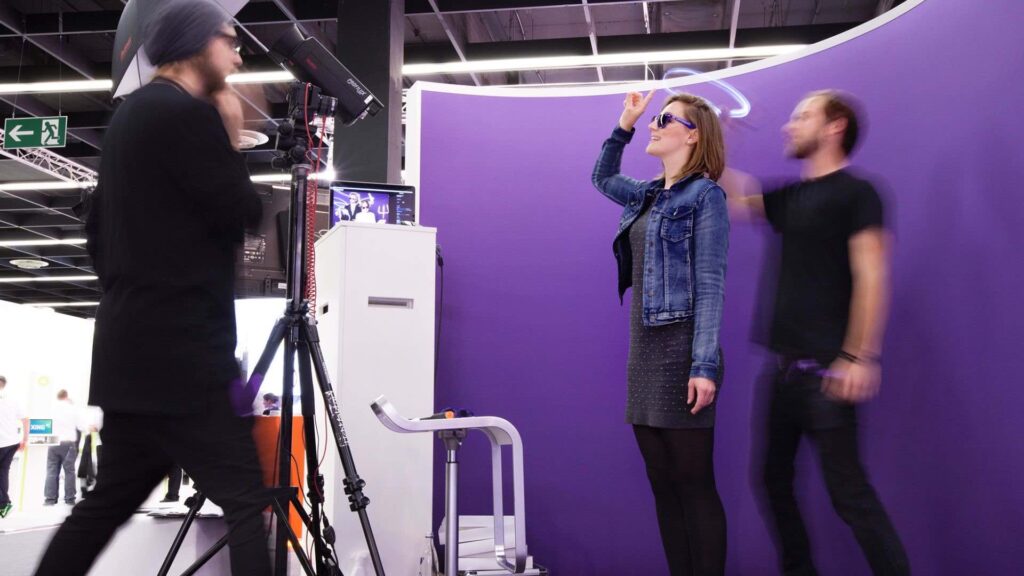Light painting booth backdrop and guests at a brand exhibition event creating unique portrait.