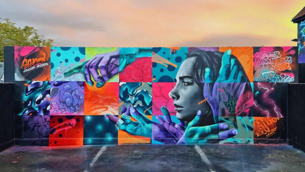 Interactive mural with AR technology featuring vibrant colours and portrait of a lady and hands for cool brand activation ideas.